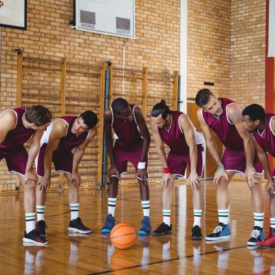 basketball-players-taking-a-break-on-basketball-court.jpg